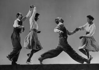 Four Black dancers lindy hopping 