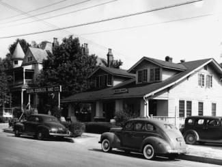 photo of a house with cars parked on the side 