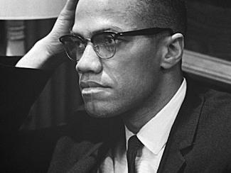photo of malcolm x with hand on his forehead