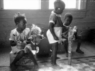 black children playing with white dolls