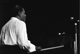 mccoy tyner sitting down playing a piano