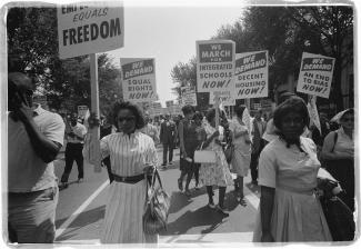 Protesters holding signs in the street 