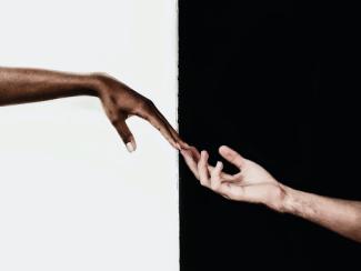 black and white hand touching 