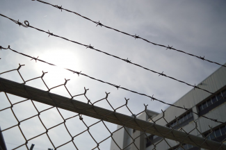 Barb wire over prison gate