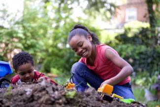 Young African American children playing outdoors