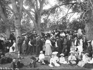 large group of people attending a picnic 