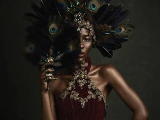 Queen with peacock feather headdress and fan