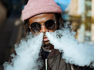 black man blowing smoke through his nose