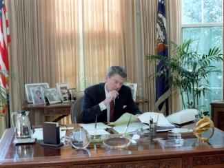 president reagan sitting at the oval office desk