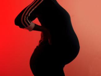 pregnant black woman in black and white tracksuit