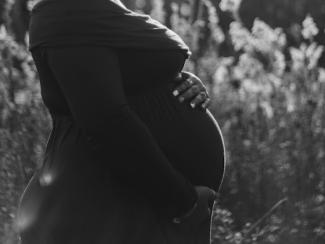 pregnant person holding their belly