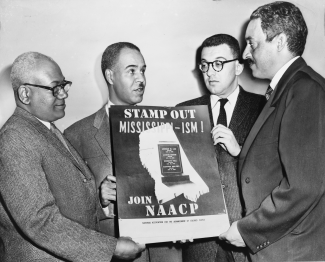 NAACP leaders holding poster