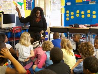 black teacher teaching a classroom