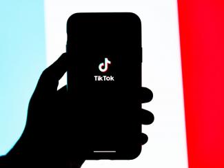 Phone with Tiktok logo in hand