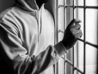 black male grabbing at bars