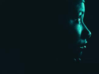 woman looking off into the distance in the dark 