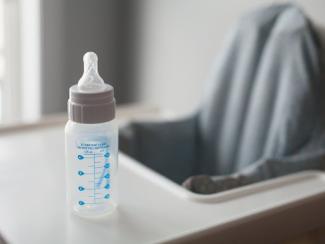 empty baby bottle on a high chair