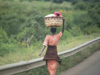 a woman carrying a basket on head