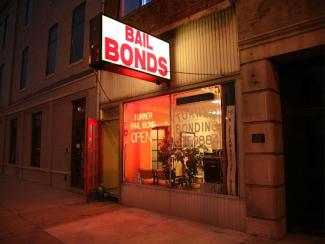 sign lit up that says bail bonds