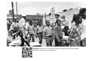 black children walking and guarded by state police
