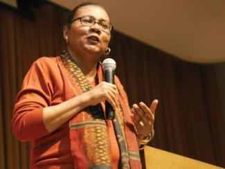 bell hooks speaking and holding a microphone