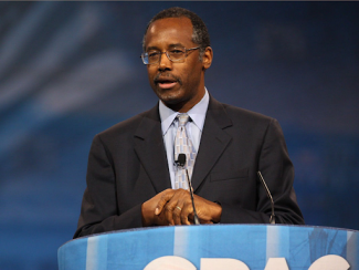ben carson in speaking in front of a podium