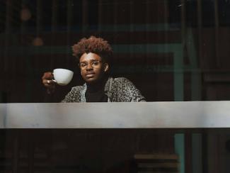 man holding coffee cup