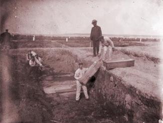 group of people in a mass grave 