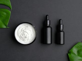 set of luxury cosmetic products on black background