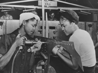 black women working on an airplane at the douglas aircraft company