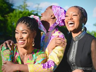 black women holding each other and smiling