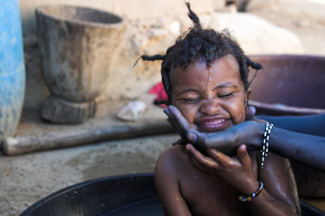smiling child getting bathed