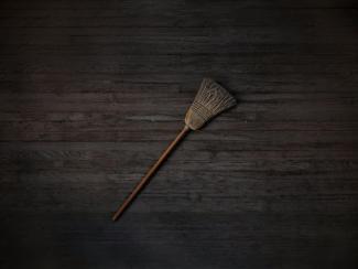broom on a wood background