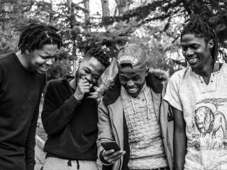 black men standing together smiling
