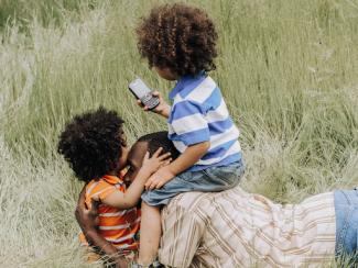 black parent playing with their children