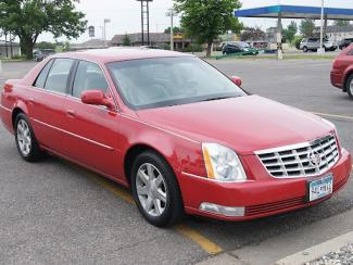 red cadillac in a parking lot