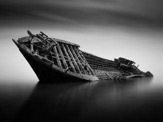 grayscale photo of a shipwreck