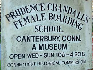 sign that says prudence crandall's female boarding school in canterbury connecticut