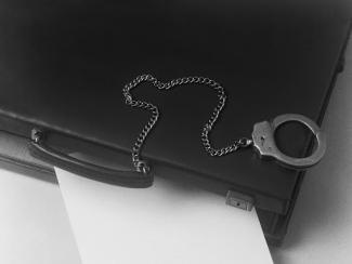 person holding a piece of paper with a chain attached to it