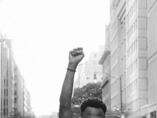 person with fist raised in the air