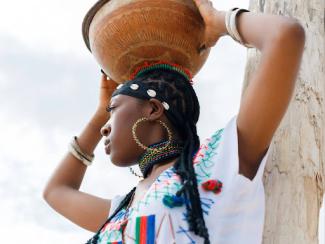 a black woman with a basket on her head