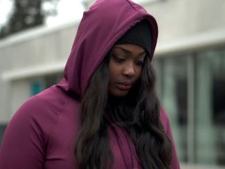 black woman with hoodie up