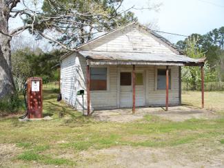 rusty pump in front of a house in tangipahoa