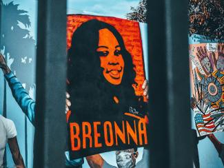 breonna taylor poster in red and black with her name across the bottom