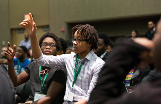 black students raising their hand