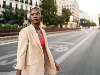young black woman walking across the street