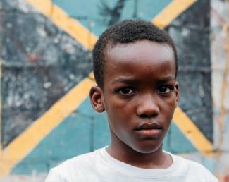 a young black boy in a white shirt