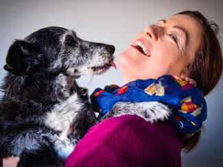 white woman embracing a dog
