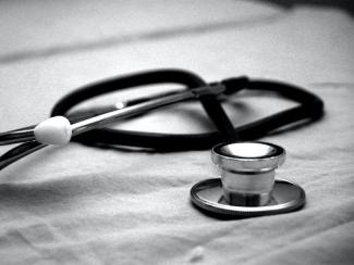 stethoscope laying on a metal table