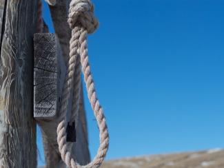 noose hanging off of a fence
